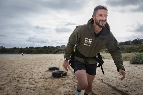 Tom Hunt training with his car tyres on Sandringham beach.