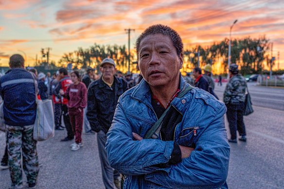 Chinese migrant workers wait by the roadside in eastern Beijing each day hoping to pick up work.