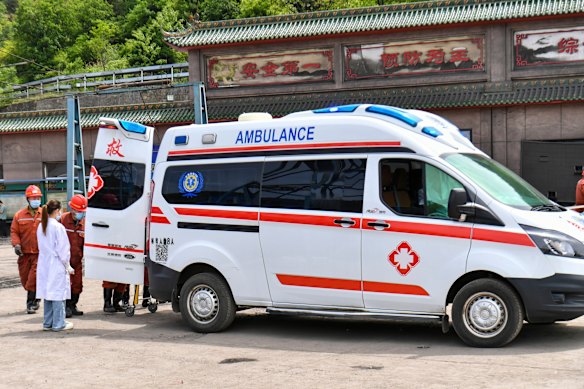 Ambulance staff wait outside the mine.