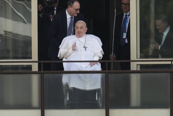 Pope Francis is wheeled out to wave to well-wishers at the Gemelli University Hospital in Rome on Sunday.