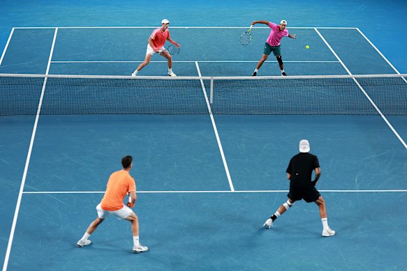 Jason Kubler plays a backhand as doubles partner Marc Polmans, and opponents and countrymen Kokkinakis and Kyrgios watch on.