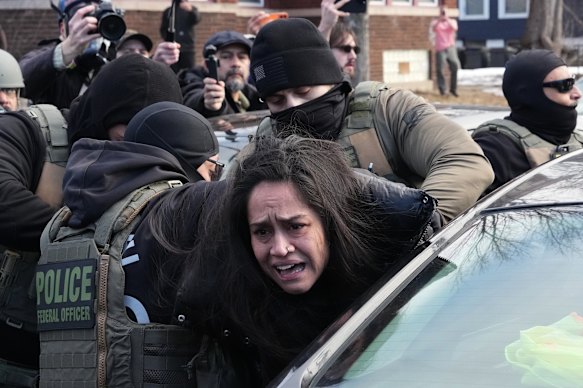 A protester is detained by federal agents this month near the scene where Renee Good was fatally shot by an ICE officer.