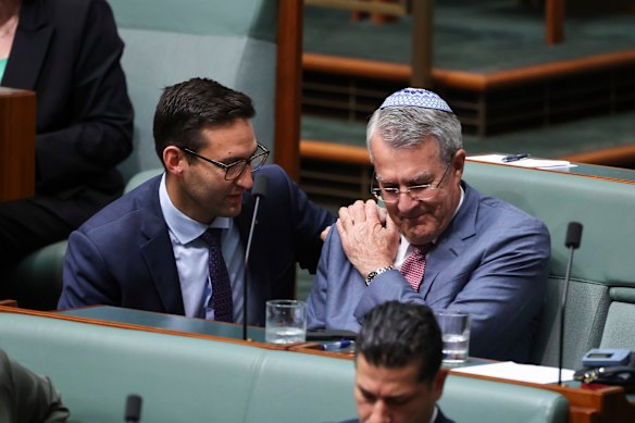 Labor MP Josh Burns consoles Mark Dreyfus after he spoke during a condolence motion for the victims of the Bondi antisemitic terror attack.