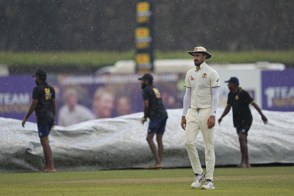 Mitchell Starc leaves the ground as rain stops play during day three of the first test cricket match betwe.