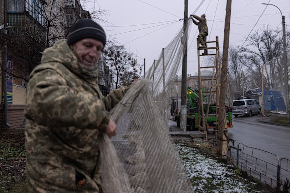 Members of the Ukrainian Armed Forces install anti-drone nets in the Izyum city centre this week.