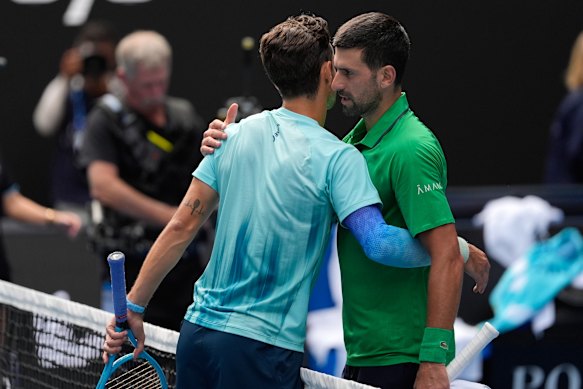 Lorenzo Musetti (left) embraces Novak Djokovic after retiring from their quarter-final match at the Australian Open.
