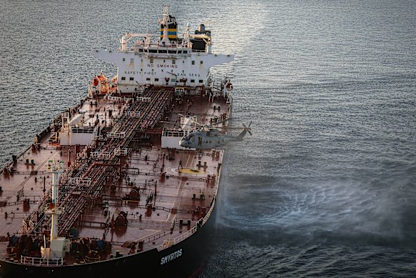 In this photo provided by the Royal Navy, Royal Marine Commandos detain sanctioned tanker, the Smyrtos, in the English Channel.