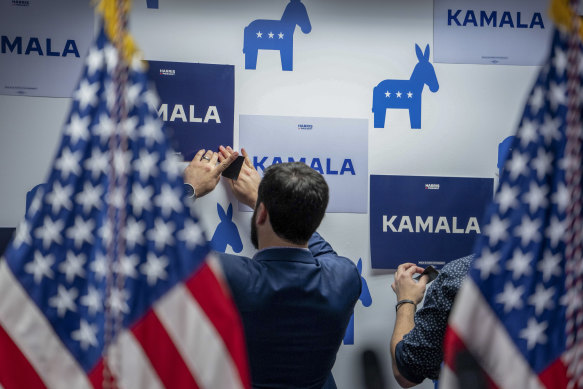 Campaign staff installing “Kamala” signs at the headquarters of the former Biden campaign office in Wilmington, Delaware, in July, after the president withdrew from the race.