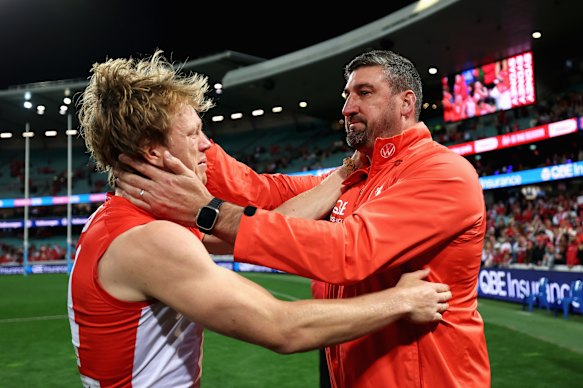 An emotional Callum Mills with Swans coach Dean Cox