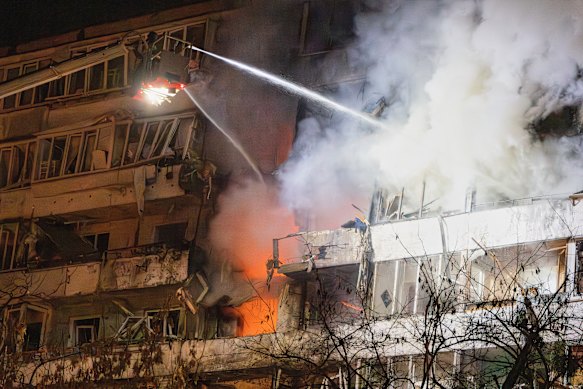 Firefighters put out a blaze after a drone hit a residential building in Kyiv overnight.