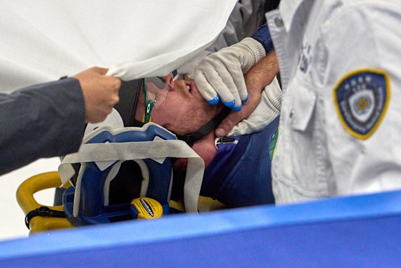 Brendan Corey is stretchered off the ice after having his neck sliced open by a competitors blade.