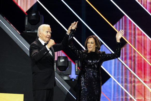 President Joe Biden welcomes Vice President Kamala Harris to the stage during the 2024 Phoenix Awards dinner in Washington in September. 
