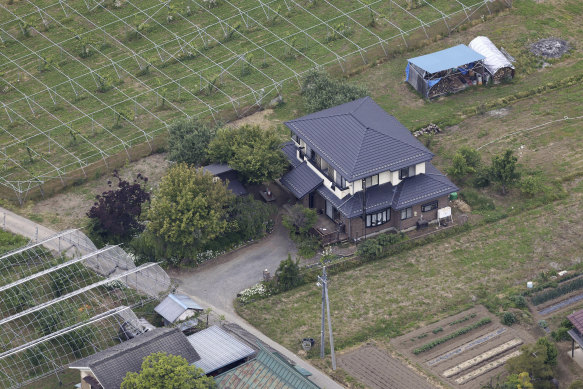 A house barricaded by a man with a rifle and a knife Friday in Nakano, central Japan.