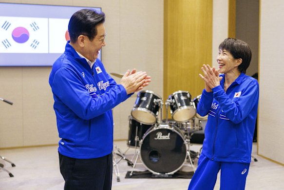 Japanese Prime Minister Sanae Takaichi (right) is popular with younger voters, in part due to her willingness to break the mould with acts like drumming KPop songs with South Korean President Lee Jae Myung (left).
