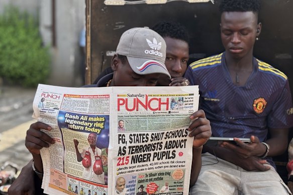 A man in Lagos reads a local newspaper with headlines about the abductions.