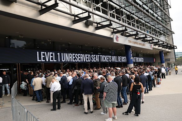 Members queue to enter the stadium.