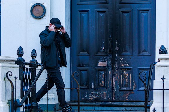 A security guard outside the East Melbourne Hebrew Congregation on Saturday, after an arson attack at the synagogue on Friday night.