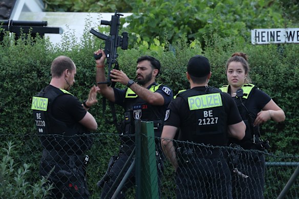 Police stand in a garden house colony in Berlin&rsquo;s Spandau district, where authorities said the suspect in the deadly Berlin Pride van attack was shot dead in a confrontation on Sunday.