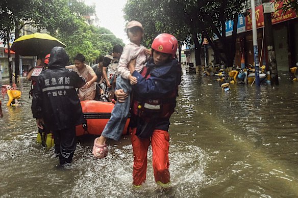 Rescuers evacuate stranded residents in the aftermath of tropical storm Maysak in Qinzhou City, south China's Guangxi Zhuang Autonomous Region Tuesday, July 7, 2026.