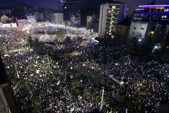 Thousands of protesters hold up their mobile phones during Saturday’s major rally in Belgrade.
