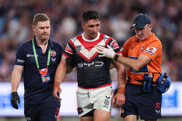 Victor Radley of the Roosters is attended to by trainers after a head clash during the NRL match with Brisbane Broncos.