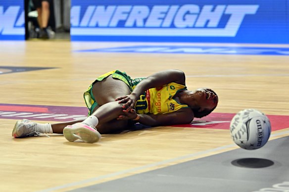 Sunday Aryang holds her knee after being injured against the Silver Ferns.