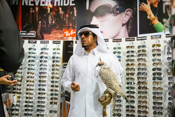 A man with a falcon shops at Hamad International Airport in Doha, Qatar.