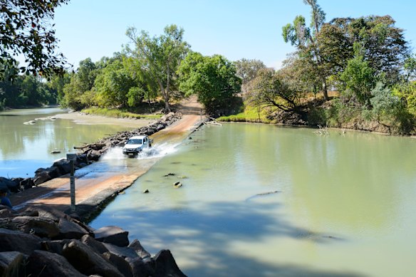 A vehicle negotiates the crocodile-infested waters of the Northern Territory’s Cahills Crossing in Kakadu National Park.