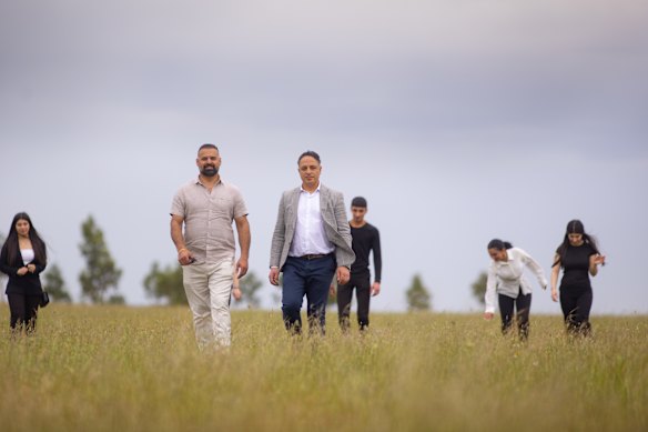 Hume councillor Sam Misho (front left), Assyrian school planning committee member Hindreen Youkhana and community members in parkland put forward as a possible school site.