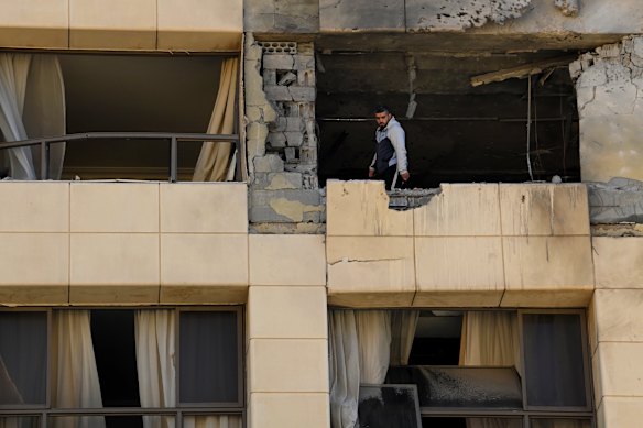 A man looks from the Ramada Plaza hotel room that was hit by an Israeli drone.
