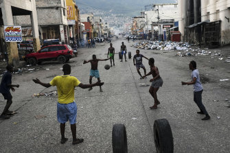 Youths play soccer on the streets of Port-au-Prince, where workers are on strike.