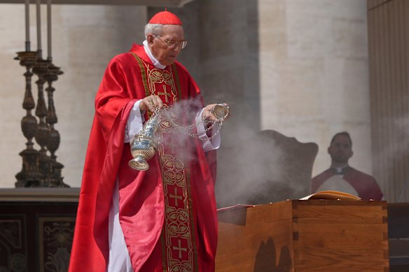 The dean of the College of Cardinals Giovanni Battista Re blesses the coffin.