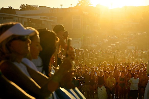 Speeches were delivered on the beach before the paddle-out.