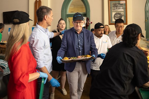 Premier Chris Minns and Prime Minister Anthony Albanese during a Christmas lunch hosted by the Rev Bill Crews Foundation.