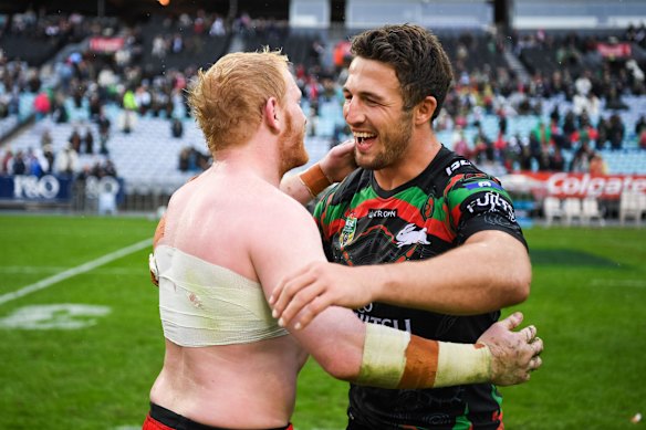  James Graham and Sam Burgess embrace after an NRL game.