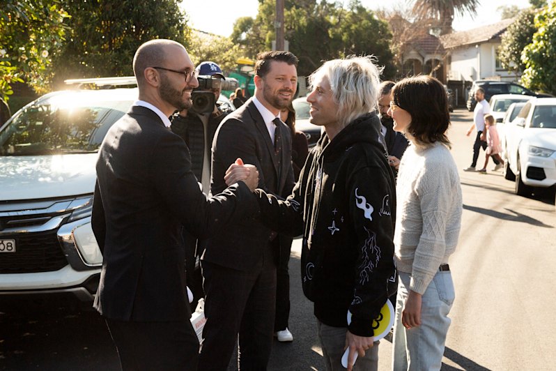 Agent Kieran Gianoudis and auctioneer Tim Snell congratulate first home buyers Wil Storch and Madi Jensen.