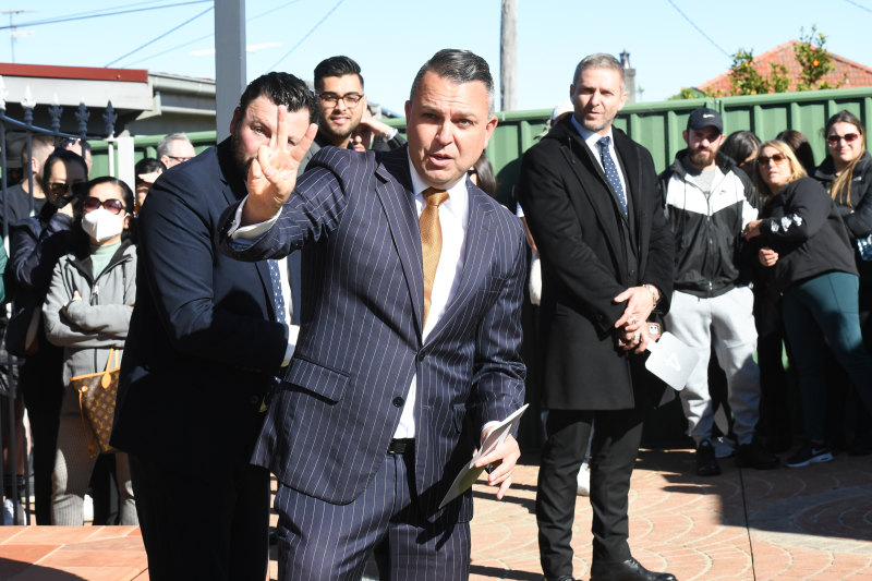 Auctioneer Clarence White prepares to sell the property.