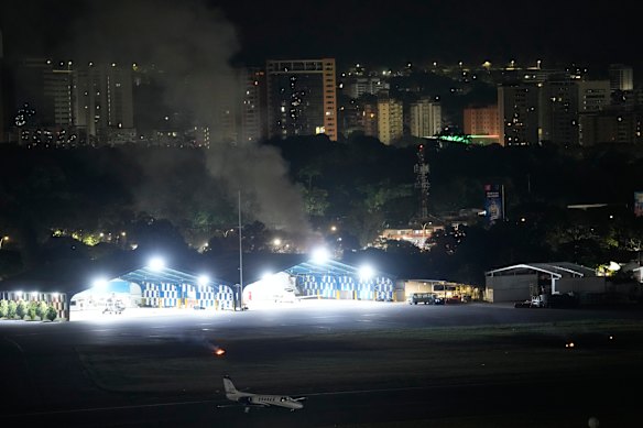 Smoke raises at La Carlota airport after at least seven explosions and low-flying aircraft were heard in Caracas.