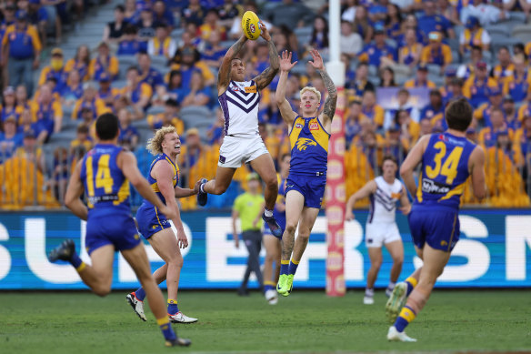 Shai Bolton of the Dockers marks the ball.