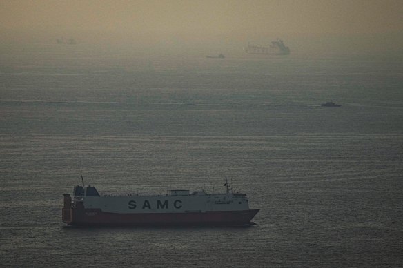 Cargo ships sail in the Arabian Gulf towards the Strait of Hormuz.