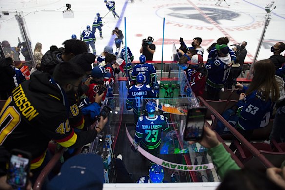 Players arrive for warm-ups during a Vancouver Canucks’ game in 2021 at Rogers Arena.