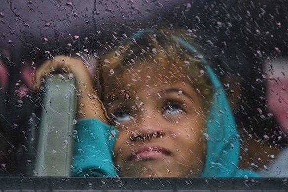 A girl looks out the bus window as she is evacuated in Santiago de Cuba.