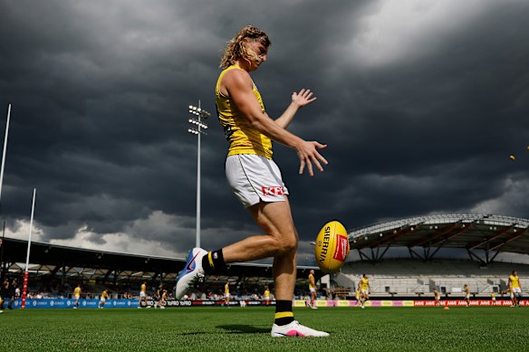 Richmond’s Hugo Ralphsmith warms up for the practice game in ballarat under threatening skies.