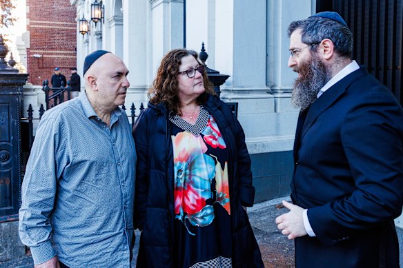 Synagogue president Danny Segal, his wife Jenny and Rabbi Dovid Gutnick outside the synagogue the morning after the attack.
