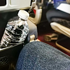 Putting your water bottle in the seat pocket could be really annoying the person in front.