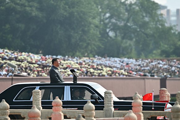 People watch Xi Jinping at the parade in Beijing’s Tiananmen Square.