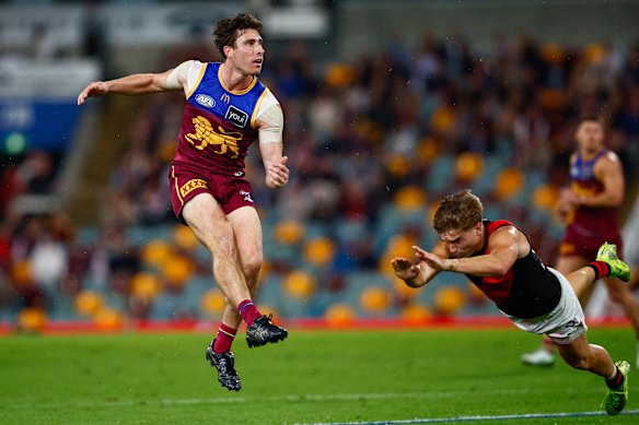 Noah Answerth of the Lions kicks a goal.