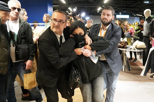 A protester is removed from Shein’s first global store opening in Paris.