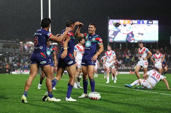 The Warriors celebrate a Te Maire Martin try against the Dragons on Saturday.