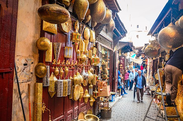 A wares-laden passageway of a medina in Fes.